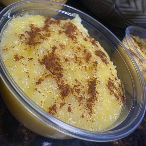 Avo's Feast Portuguese rice pudding with cinnamon in a clear plastic container.